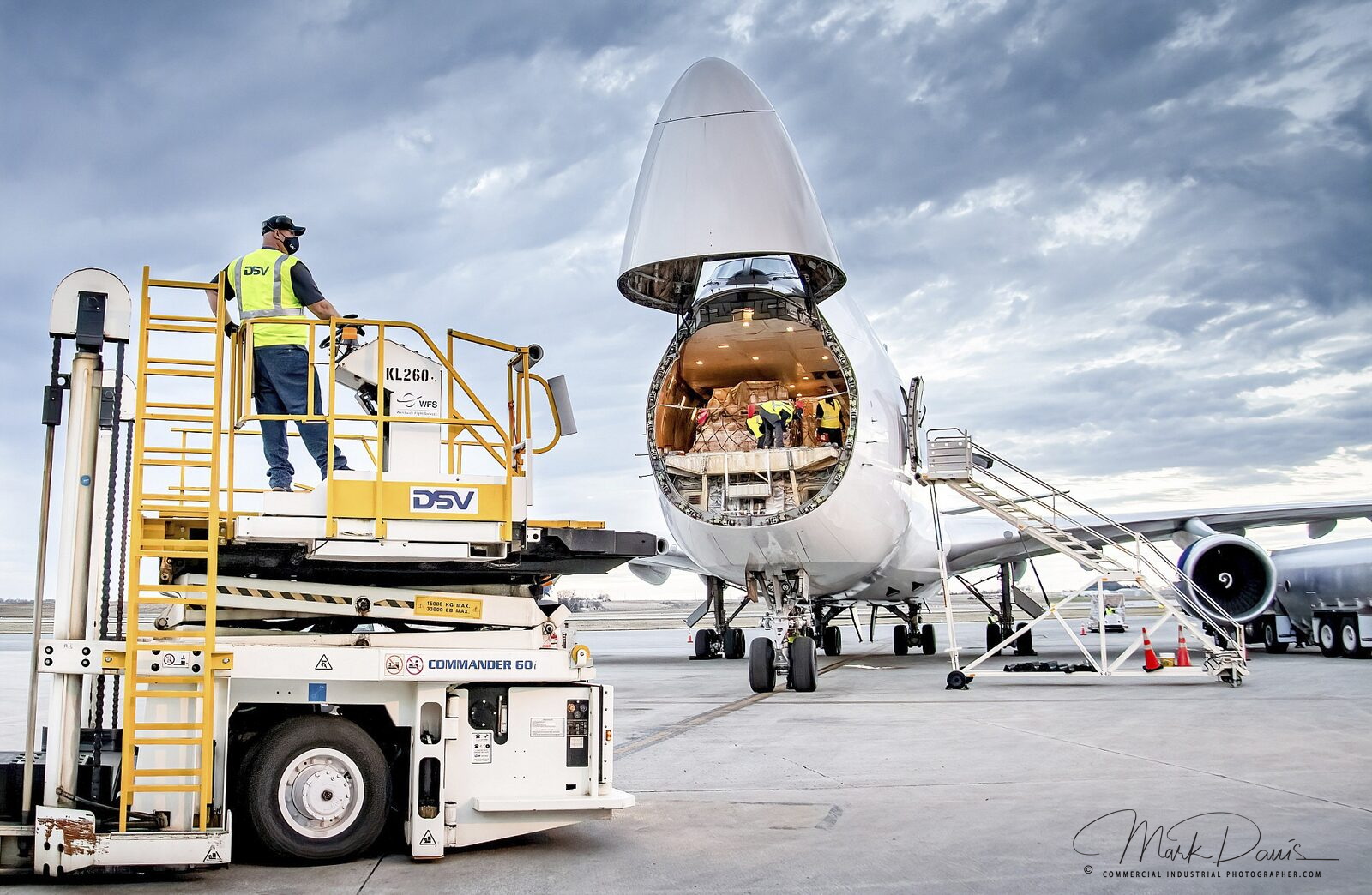 Freighter aircraft nose open for cargo loading on the tarmac