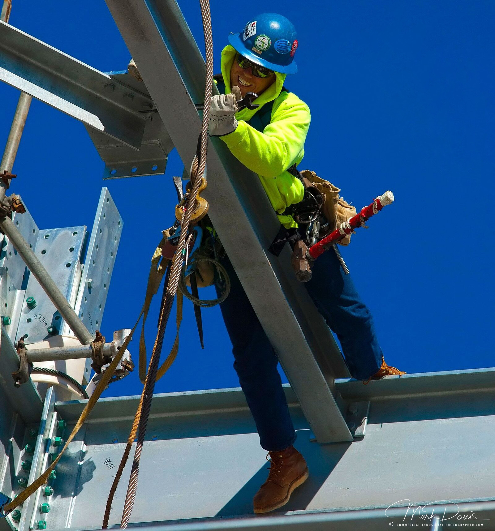 Iron rigger working on structural steel beam at an industrial construction site