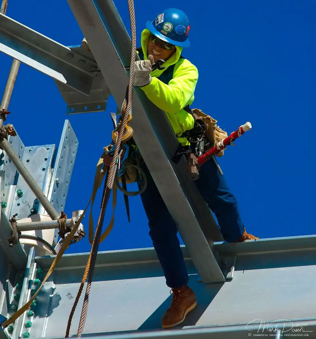 Iron rigger working on structural steel beam at an industrial construction site