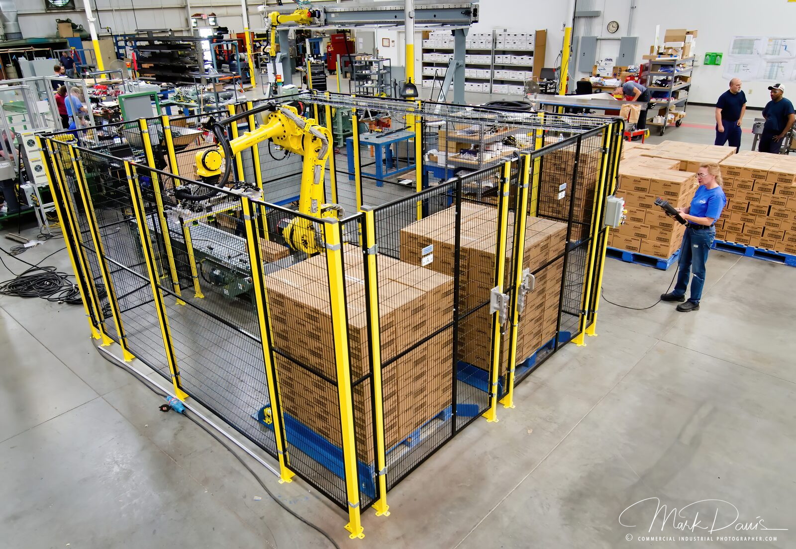 Robotic palletizing cell stacking boxes on a manufacturing floor