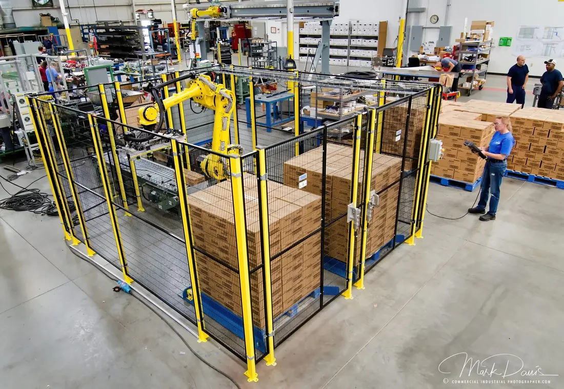 Robotic palletizing cell stacking boxes on a manufacturing floor