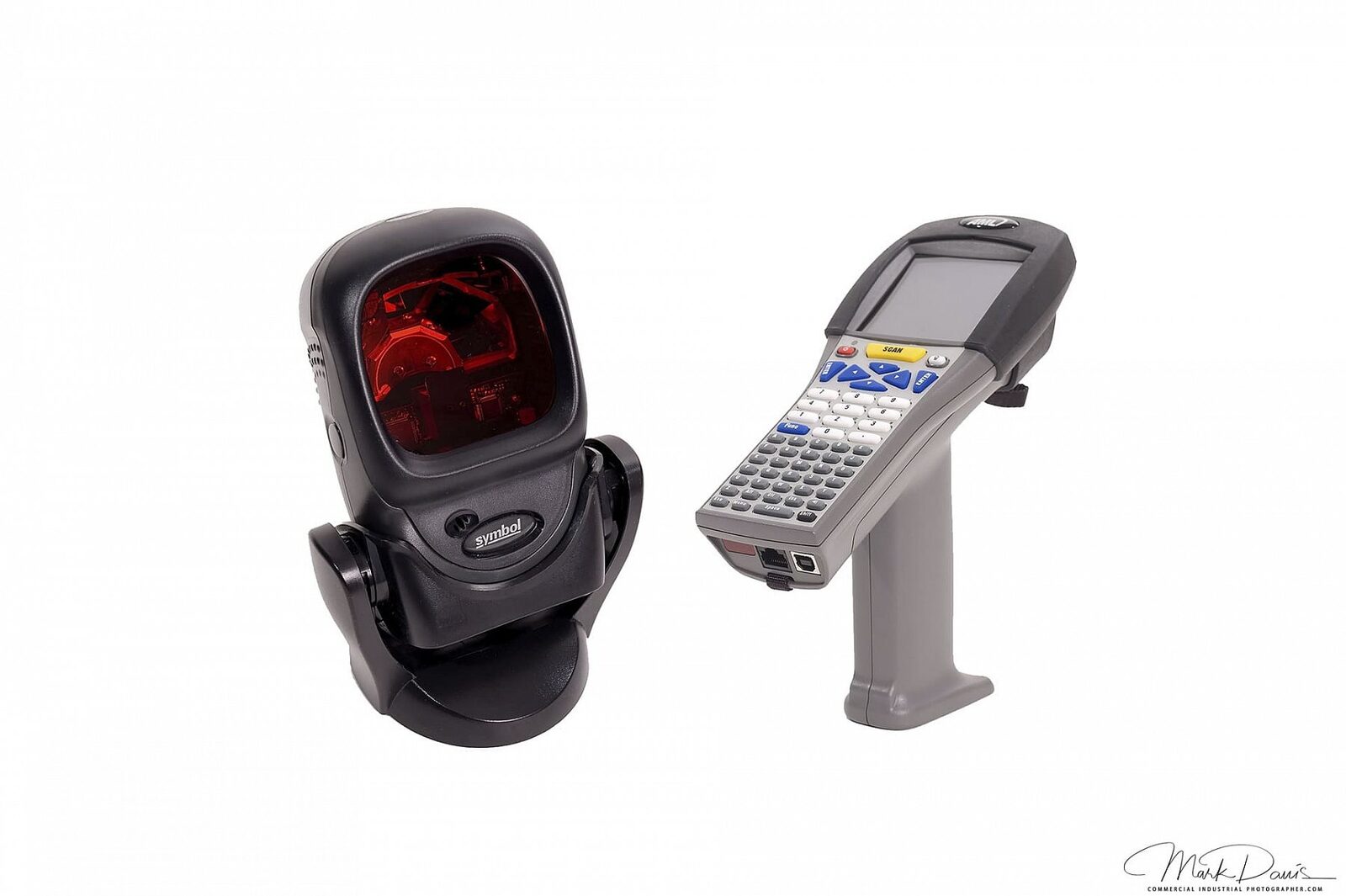 Handheld barcode scanner and industrial computer photographed on white background
