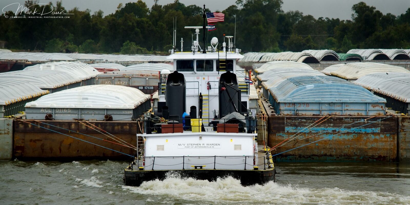 Towboat pushing barges on the Mississippi River, secure maritime access site