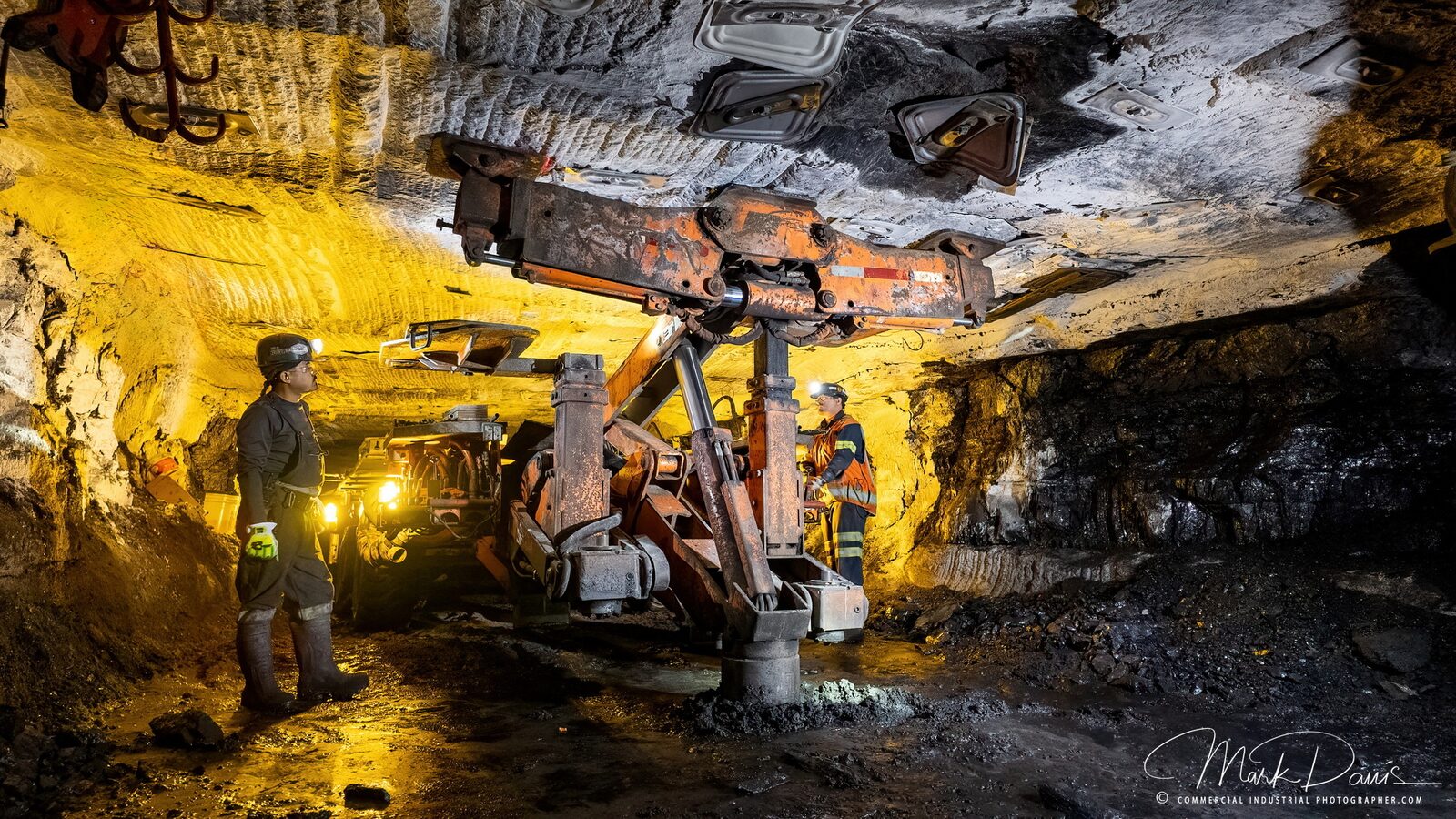Miners working underground in an Alabama coal mine with mining equipment